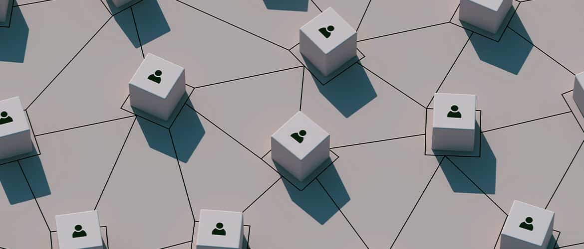 An image of cubes with icons of people on a surface structured in the shape of red, which symbolizes the connection and collaboration between talents at a global level.
